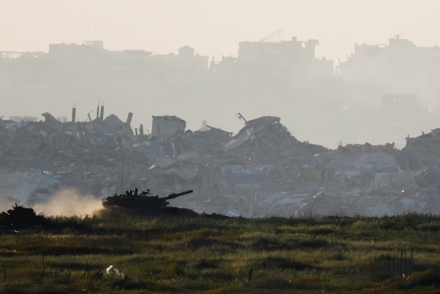 A tank manoeuvres inside Gaza, as seen from Israel's border with Gaza, Israel March 19, 2025. REUTERS/Amir Cohen/File Photo---